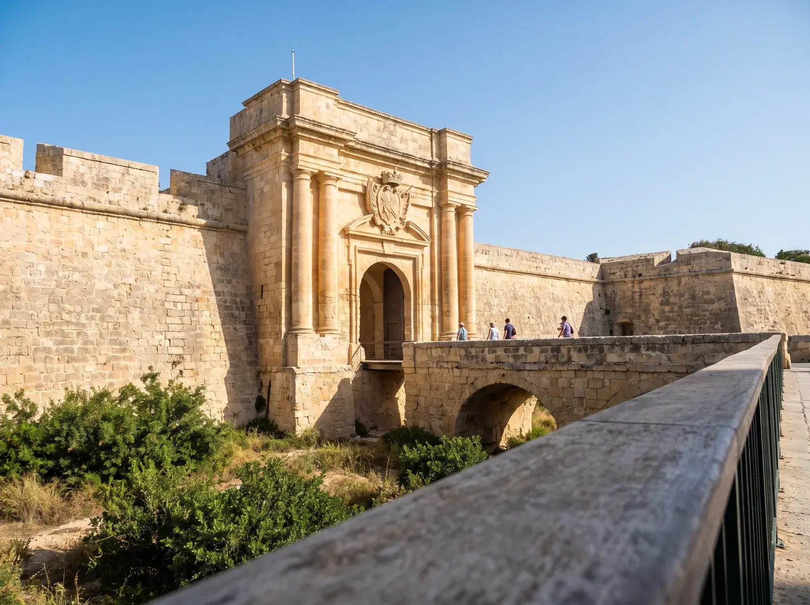 Mdina'nın süslü taş ana kapısına kuru hendek üzerindeki köprüden yaklaşım.